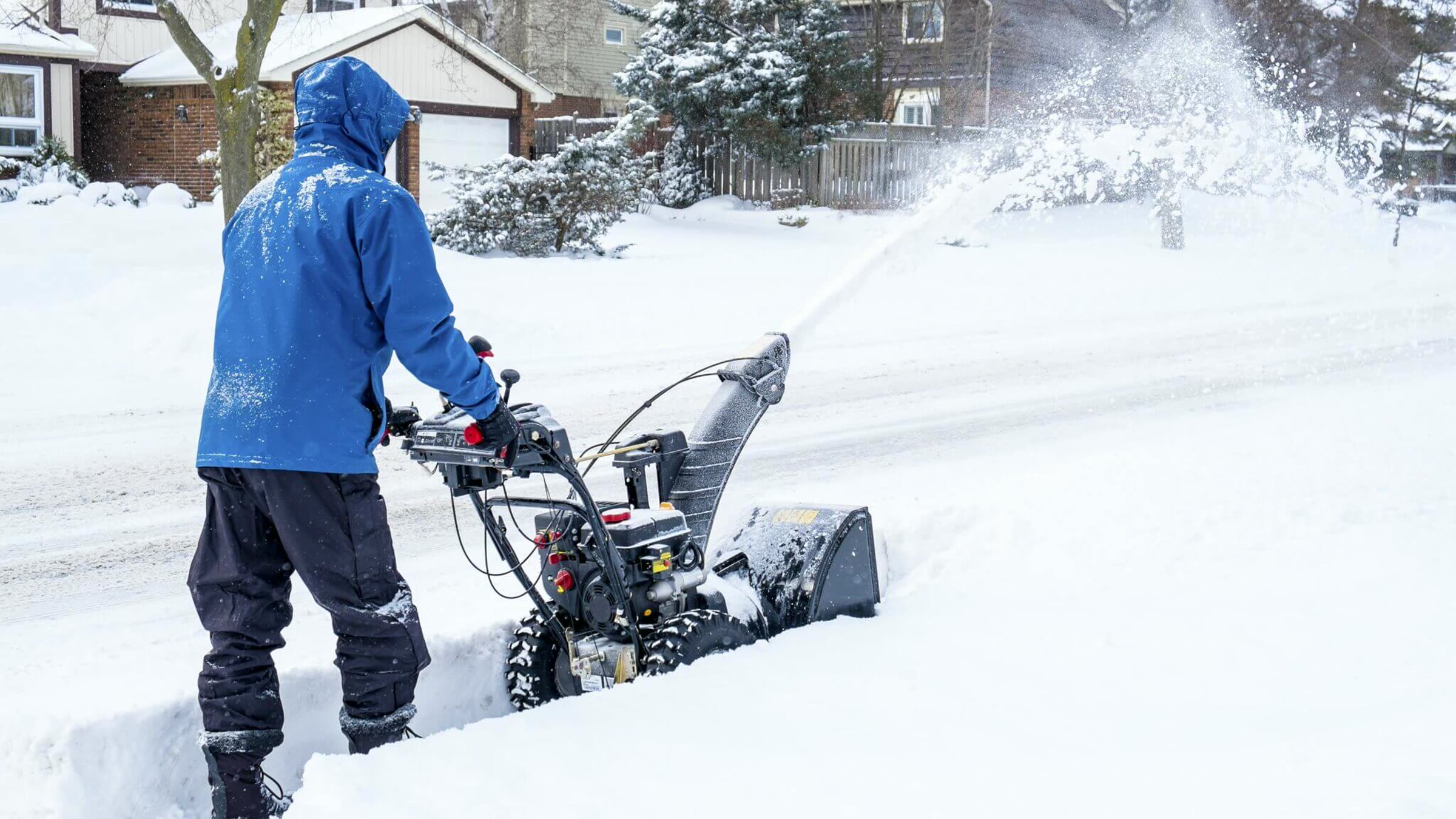 Clearing a residential driveway with a snow blower